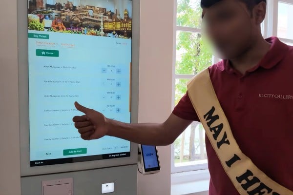 A still from a social media video shows a member of staff helping tourists at the KL City Gallery in the Sultan Abdul Samad Building, Kuala Lumpur, Malaysia. Photo: YouTube A still from a social media video shows a member of staff helping tourists at the KL City Gallery in the Sultan Abdul Samad Building, Kuala Lumpur, Malaysia. Photo: YouTube