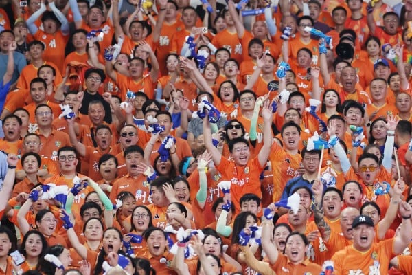 Fans of Team Yangzhou celebrate a goal during a football match against Team Nanjing on August 15. Photo: China News Service via Getty Images
