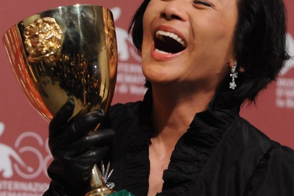 Actress Deanie Ip poses with her Volpi Cup. File photo: AFP