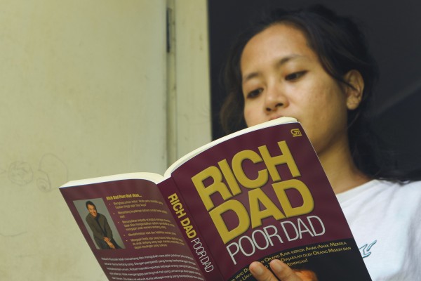 A young woman in Indonesia reads Robert Kiyosaki’s Rich Dad, Poor Dad. The 1997 bestseller was also a huge hit across Asia. Photo: Shutterstock A young woman in Indonesia reads Robert Kiyosaki’s Rich Dad, Poor Dad. The 1997 bestseller was also a huge hit across Asia. Photo: Shutterstock
