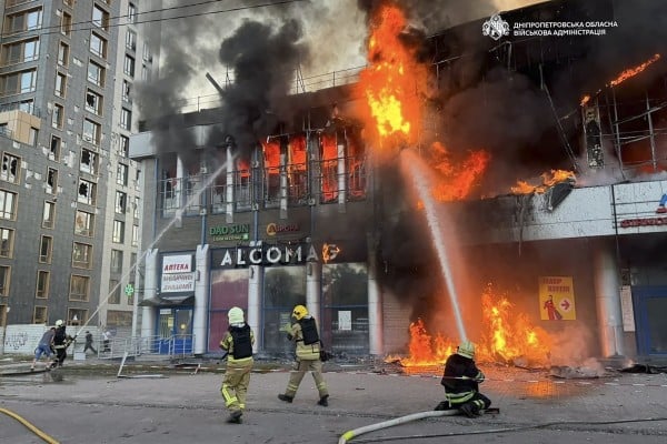 Ukrainian firefighters work at the site of a Russian strike on a shopping centre in Dnipro on Friday. Photo: Handout via EPA Ukrainian firefighters work at the site of a Russian strike on a shopping centre in Dnipro on Friday. Photo: Handout via EPA