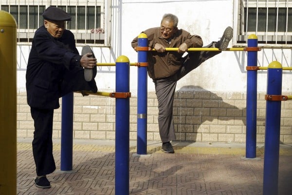 Two elderly Beijing residents stretch at an exercise park. Photo: AFP/File photo Two elderly Beijing residents stretch at an exercise park. Photo: AFP/File photo