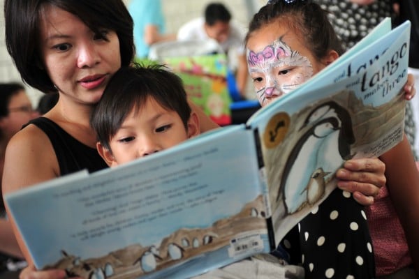 Children take part in a reading event outside the National Library in Singapore 2014. Photo: Xinhua Children take part in a reading event outside the National Library in Singapore 2014. Photo: Xinhua
