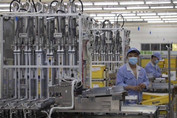 Workers at SMC, a Japanese pneumatic engineering company, assemble products at a factory in Beijing. Photo: AP Workers at SMC, a Japanese pneumatic engineering company, assemble products at a factory in Beijing. Photo: AP