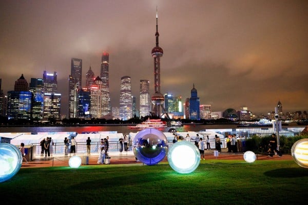 People walk on the North Bund with Shanghai’s Lujiazui financial district in the background. Photo: Reuters People walk on the North Bund with Shanghai’s Lujiazui financial district in the background. Photo: Reuters