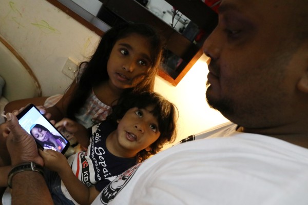 Sethumdi, 7, and her brother Dinath, 3, who are in Hong Kong, make a video call to Rodel, who is in Canada, on Kellapatha’s mobile phone. Photo: Nora Tam