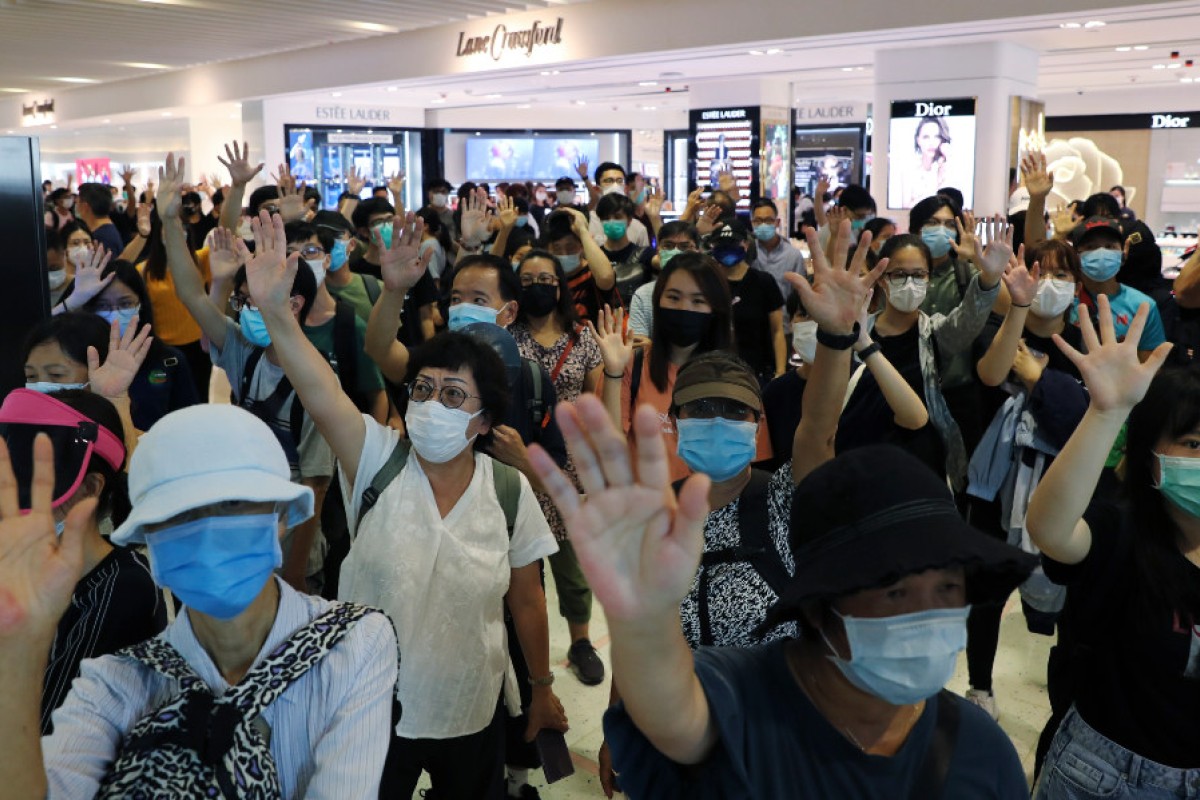 People stage a singalong protest at Harbour City in Tsim Sha Tsui, calling on Chief Executive Carrie Lam Cheng Yuet-ngor to step down.