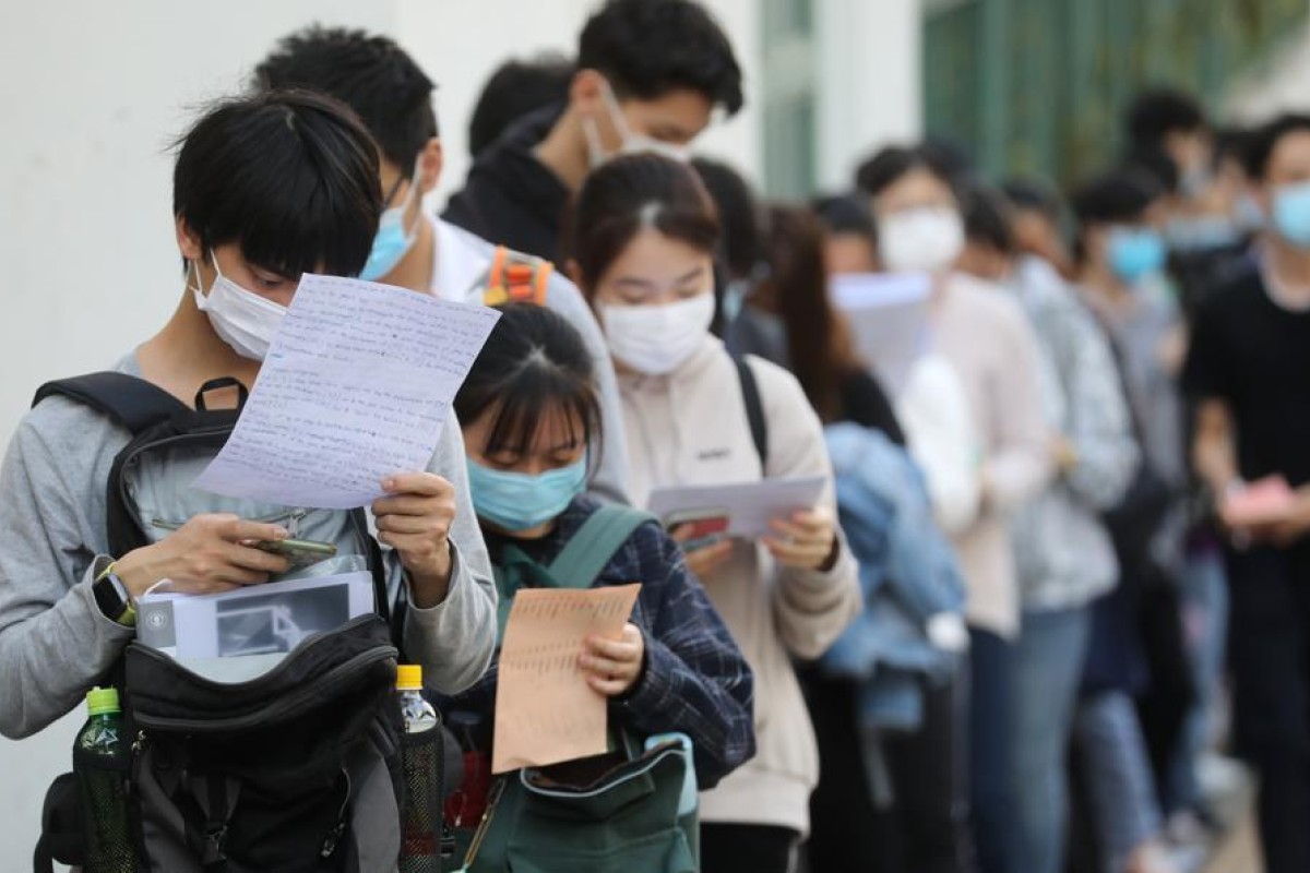 Secondary school students waiting to take the DSE exam at the Hong Kong Sze Yap Commercial and Industrial Association Wong Tai Shan Memorial College, Shek Kip Mei.