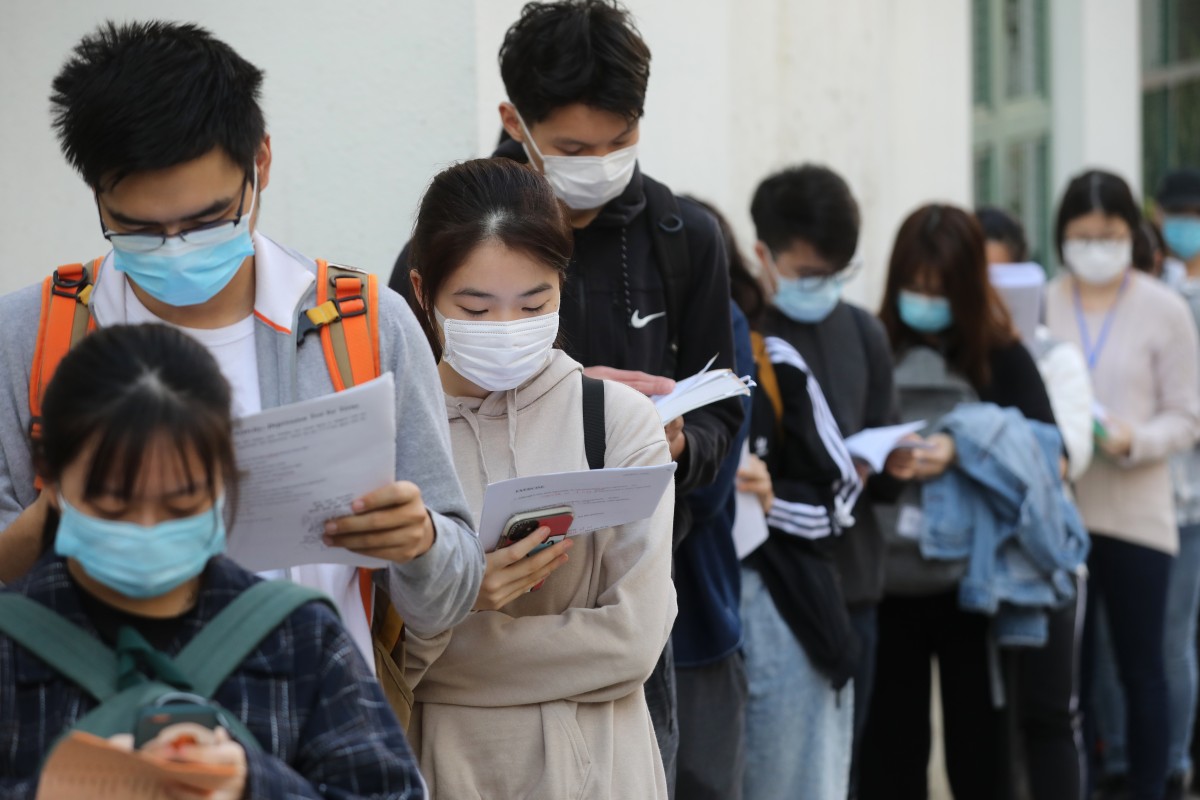 Secondary school students wait to take the DSE exam at Hong Kong Sze Yap Commercial and Industrial Association Wong Tai Shan Memorial College, Shek Kip Mei.