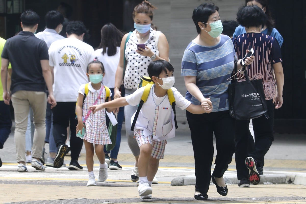 Primary school students leave the school premises in Causeway Bay. Due to the increased cases of COVID-19, the government has taken the precaution of suspending school (kindergarten, primary and secondary school) and allow students to begin an early summer holiday. Photo: SCMP/ Dickson Lee