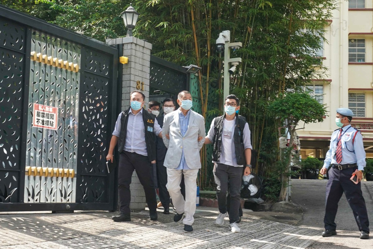 Hong Kong media mogul Jimmy Lai Chee-ying was arrested and brought out by police from his apartment in Ho Man Tin early on Monday. Photo: SCMP / Felix Wong