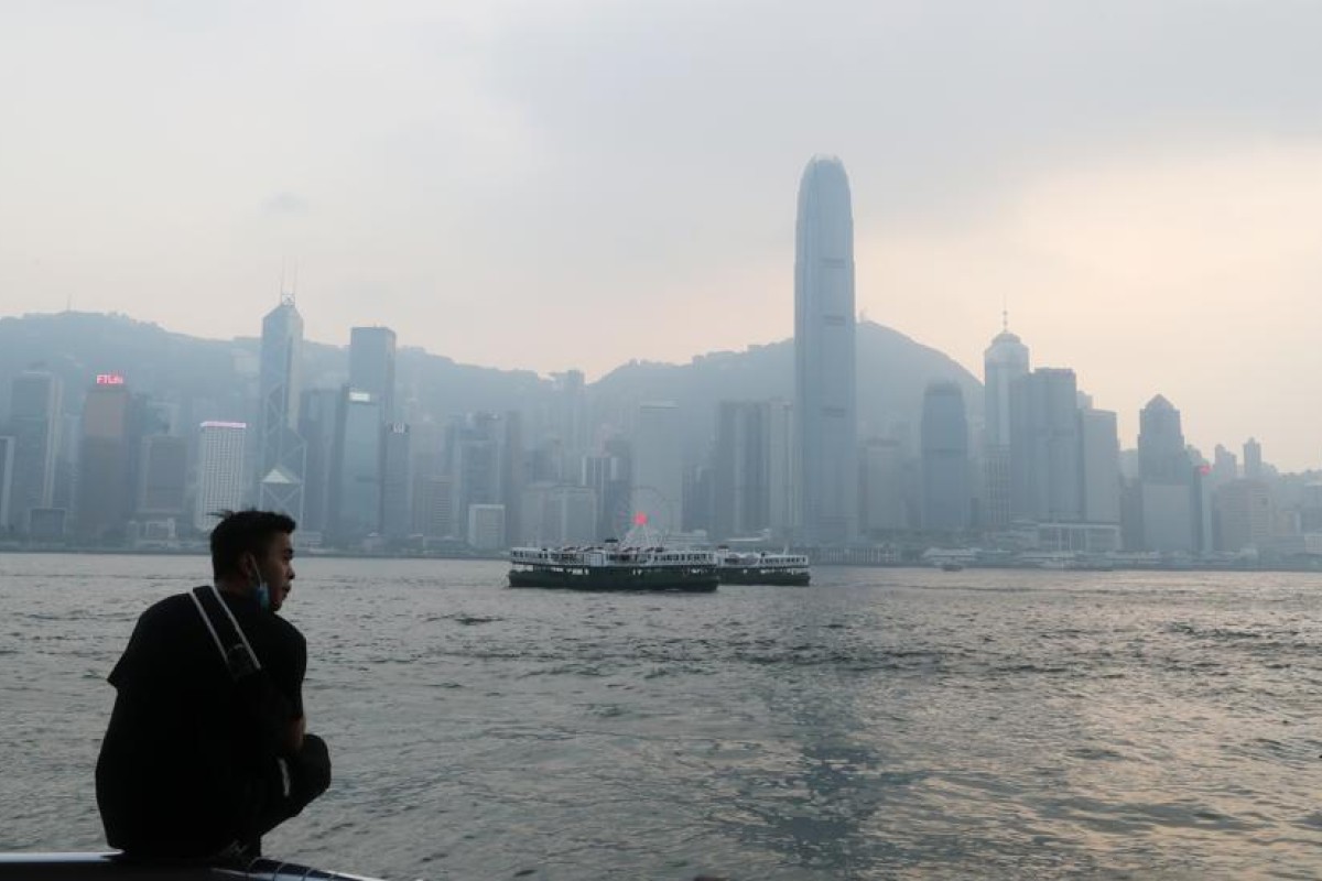 A man looks out over the Hong Kong skyline from Tsim Sha Tsui as the Air Quality Health Index recorded high air pollution levels on Tuesday. Photo: SCMP/ Edmond So