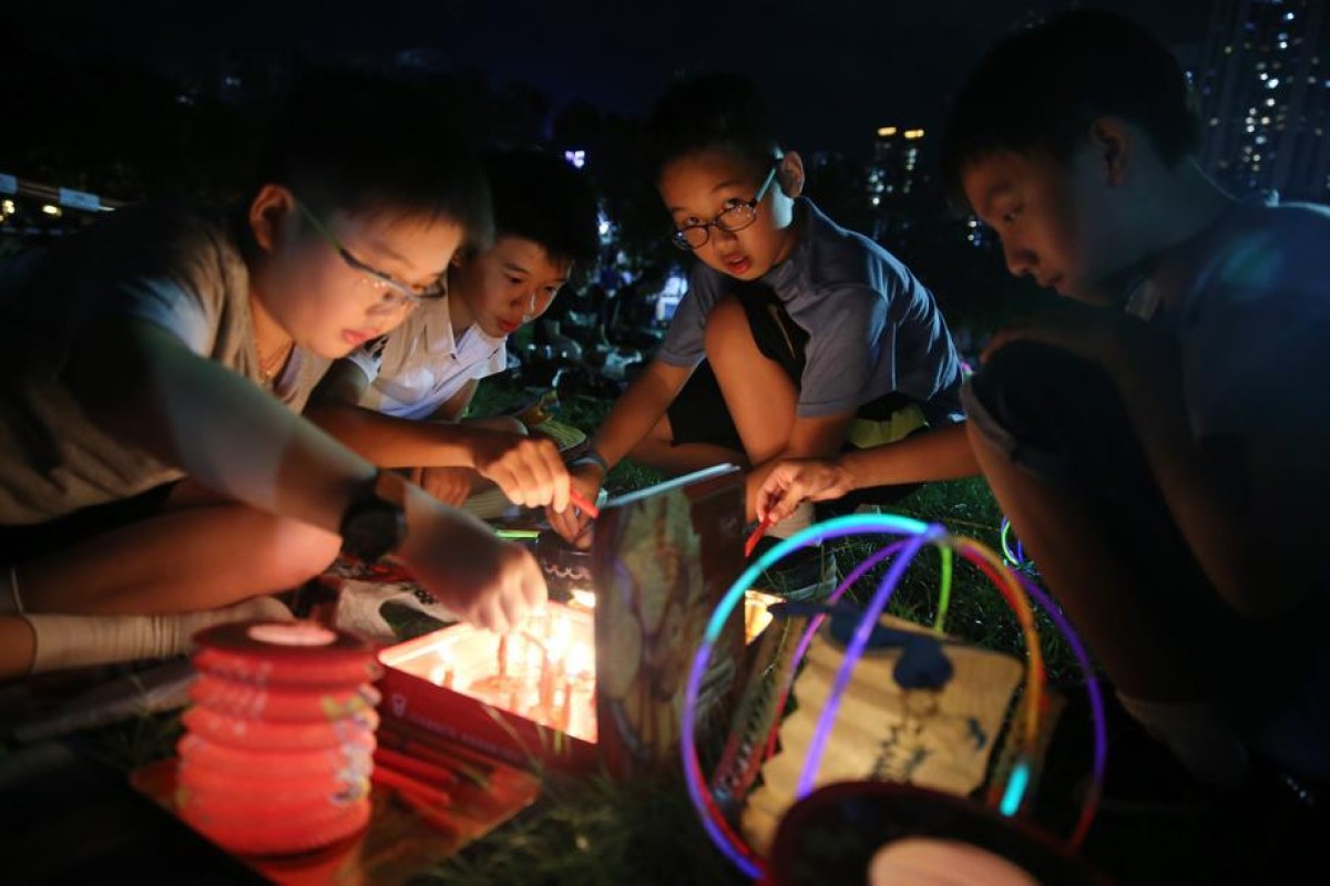 Children play with candles and lanterns to celebrate Mid-Autumn Festival at Victoria Park in Causeway Bay. Photo: SCMP/ Sam Tsang