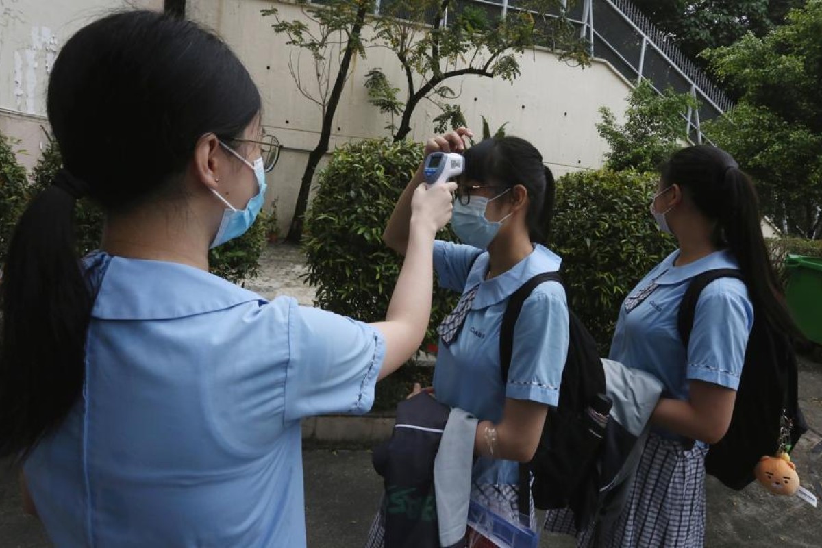 Measures like temperature taking and half-days are in place to prevent the spread of Covid-19. Photo: SCMP
