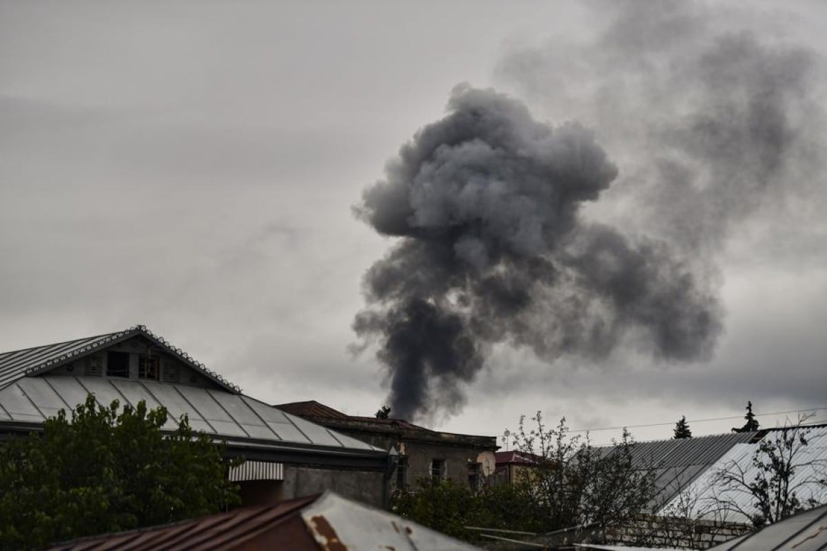 Smoke rises behind houses after shelling in the breakaway Nagorno-Karabakh region's main city of Stepanakert on October 7, 2020, during the ongoing fighting between Armenia and Azerbaijan over the disputed region. Photo: AFP