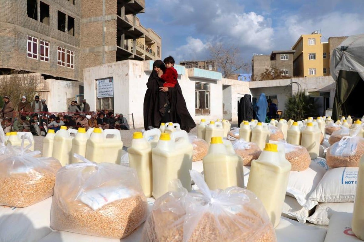 Afghan families receive food aid distributed by the World Food Programme in Herat last year. Photo: EPA