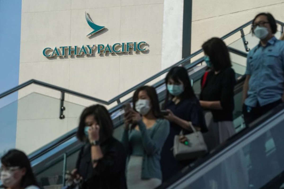 Cathay Pacific Airways employees leave the company’s headquarters on Wednesday. Photo: SCMP/ Felix Wong