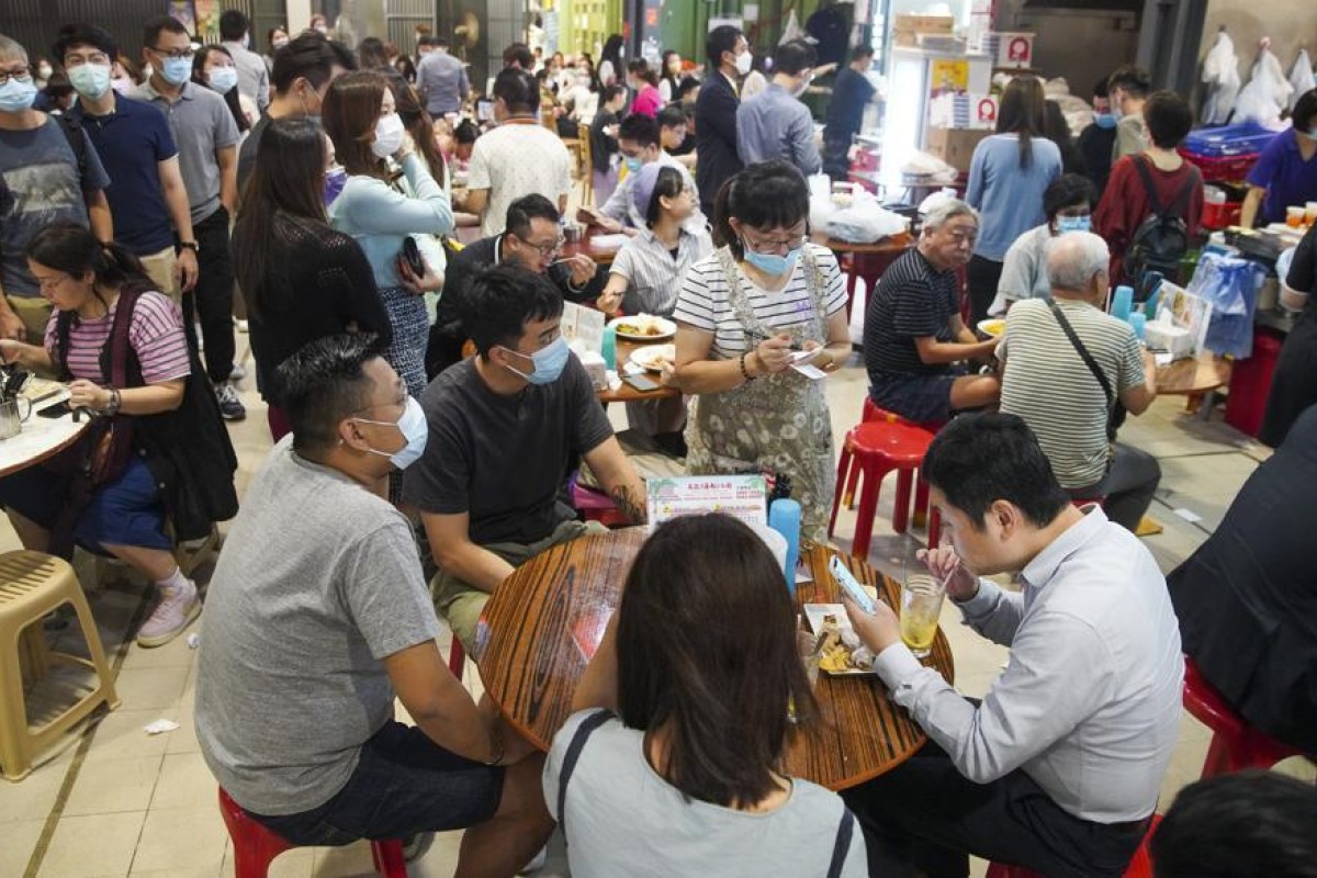 People eat lunch inside Haiphong Road Temporary Cooked Food Hawker Bazaar in Tsim Sha Tsui. Photo: SCMP/ Winson Wong