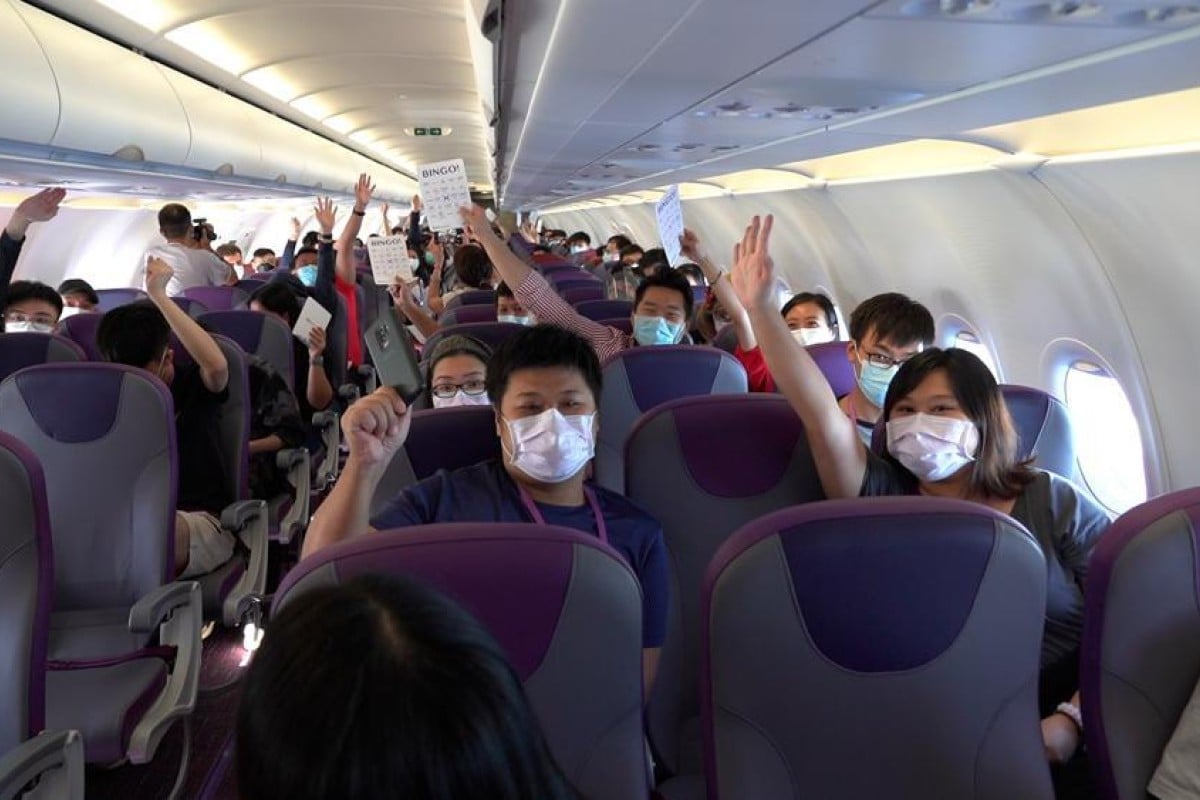 Passengers on board the HK Express flight play a game with crew members. Photo: Handout
