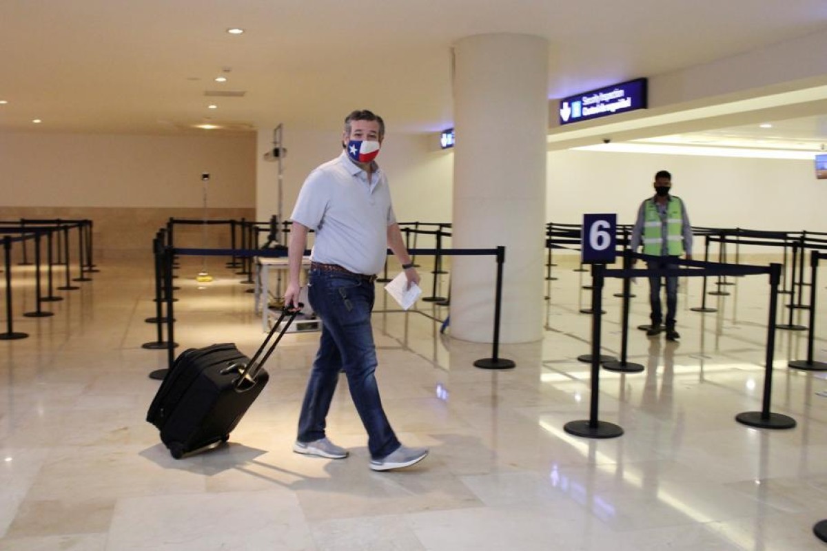 US Senator Ted Cruz (R-TX) carries his luggage at the Cancun International Airport before boarding his plane back to the US. Photo: Reuters