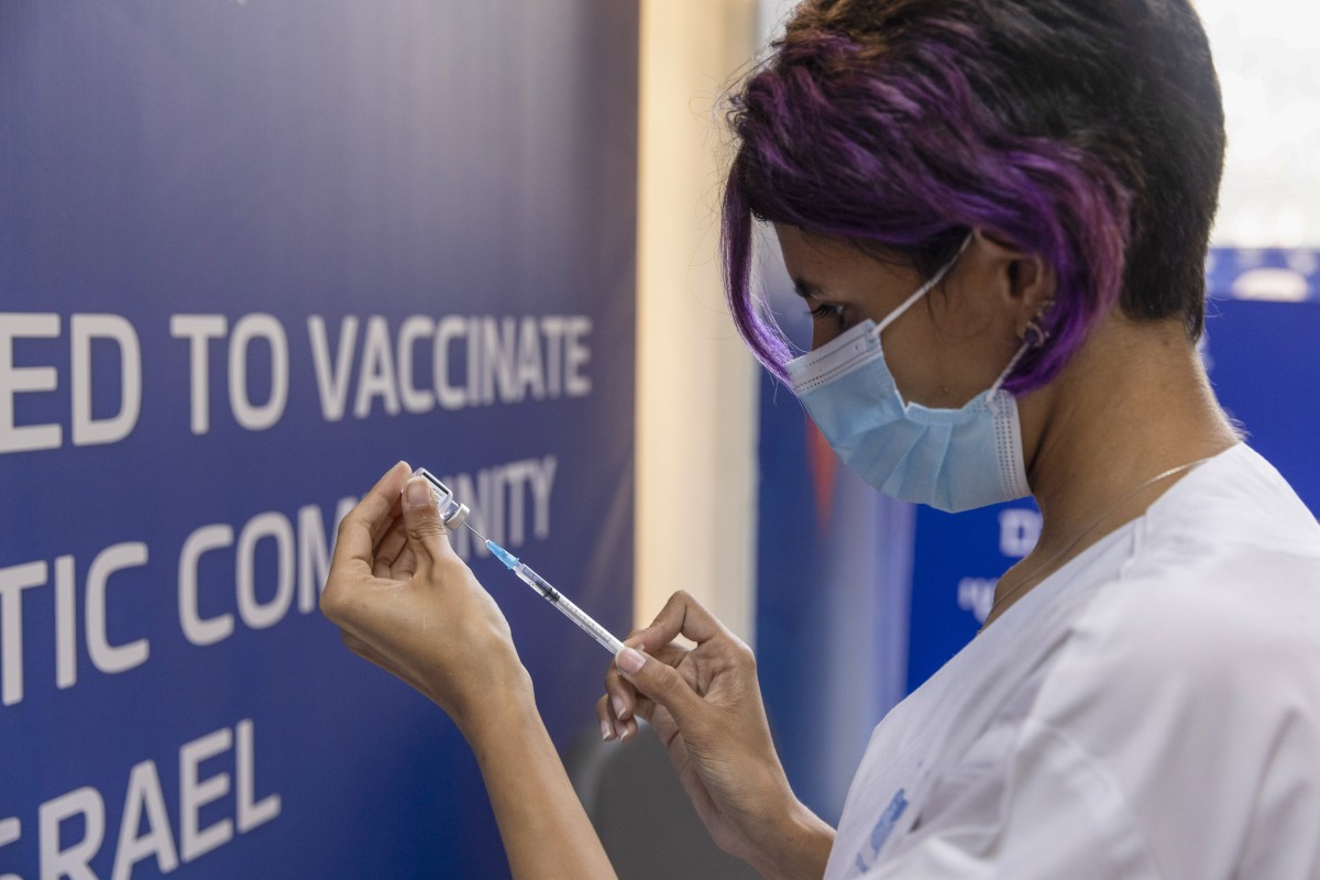 A health worker prepares a booster dose of the Pfizer-BioNTech Covid-19 vaccine at Ichilov medical center in Tel Aviv, Israel. Photo: Bloomberg