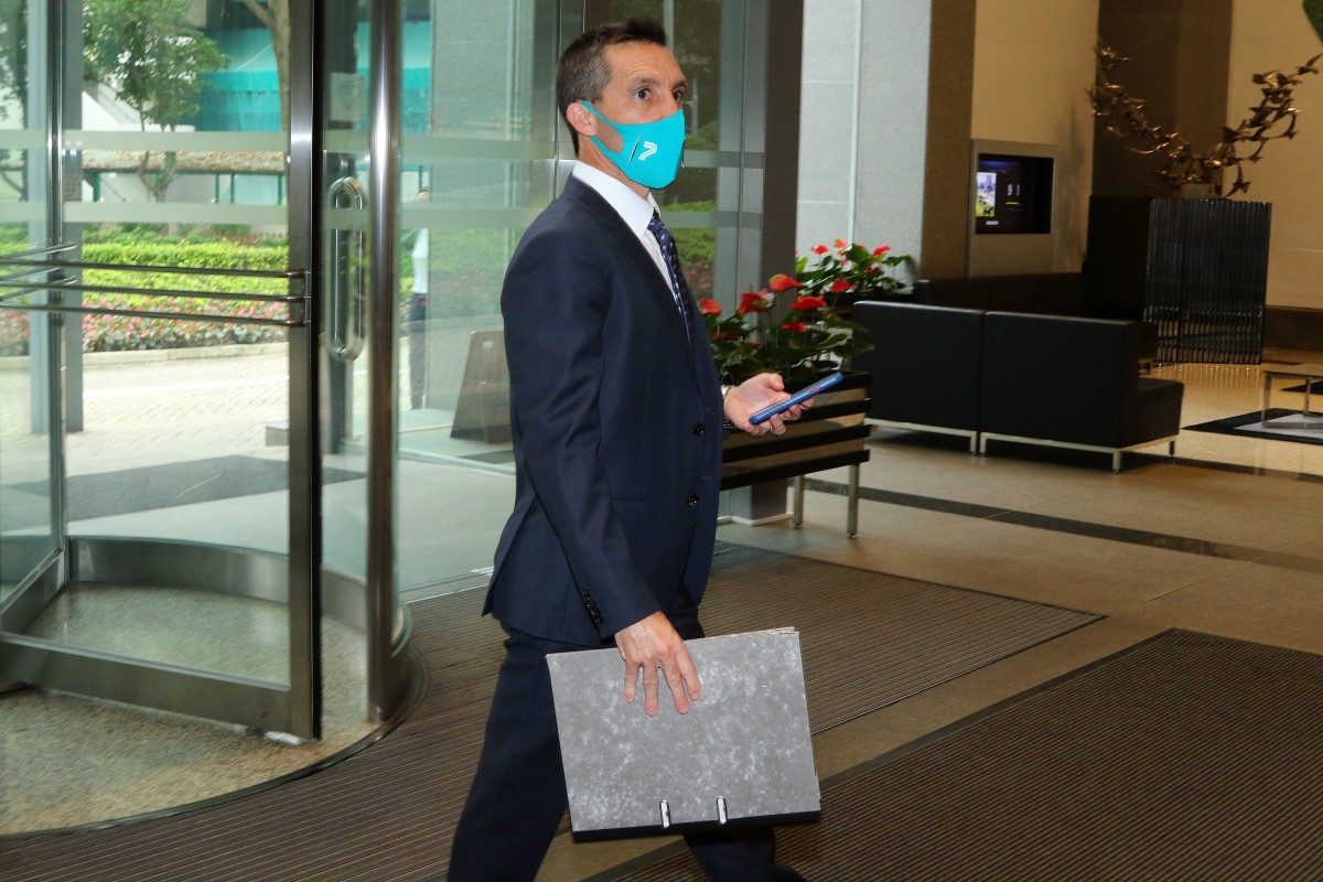 Neil Callan enters HKJC headquarters for his licensing committee hearing. Photos: Kenneth Chan