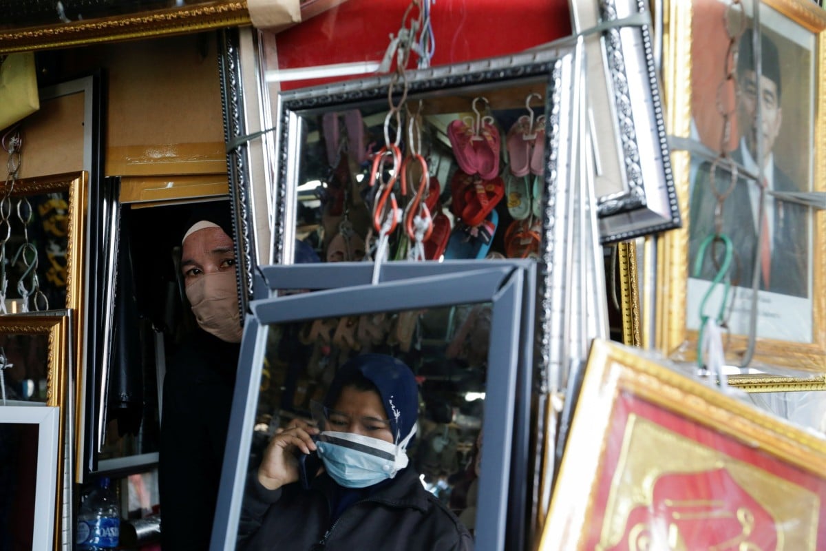 Women wear protective face masks during a coronavirus outbreak in Jakarta, Indonesia. Photo: Reuters