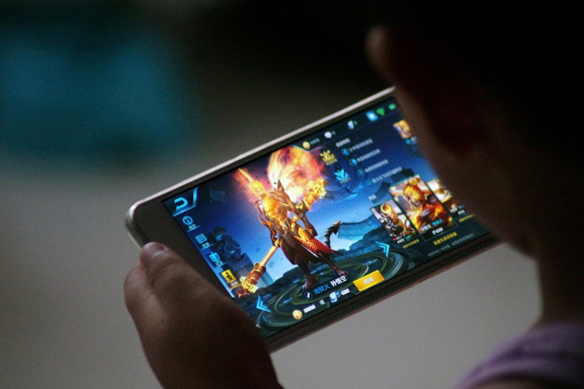 A child plays the game “Honour of Kings” by Tencent at home in China. Photo: Reuters