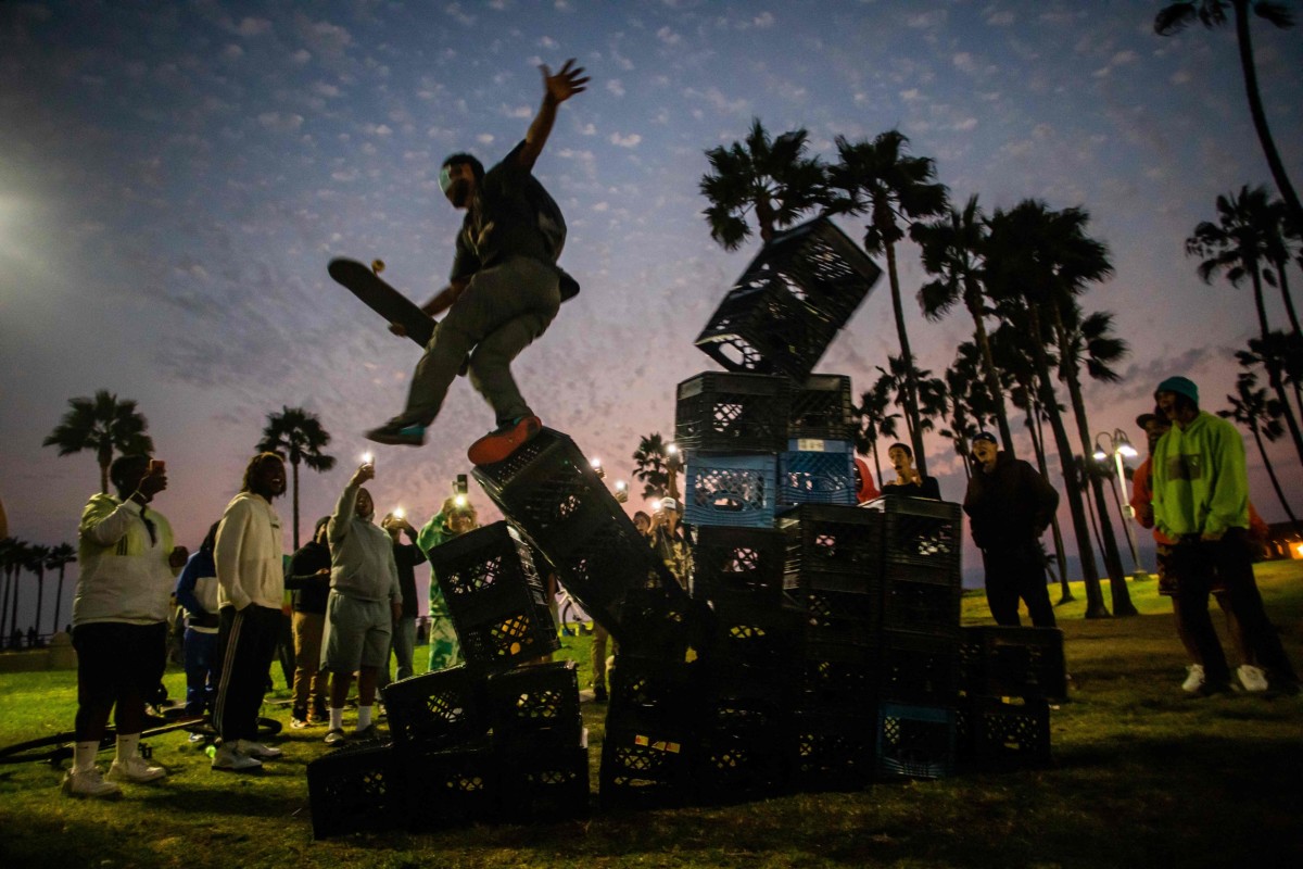 A man falls off a pyramid of milk crates while he participates in the Milk Crate Challenge. Some doctors are warning that the injuries from the challenge are putting more stress on hospitals at a time when emergency rooms are overwhelmed because of the coronavirus. Photo: AFP
