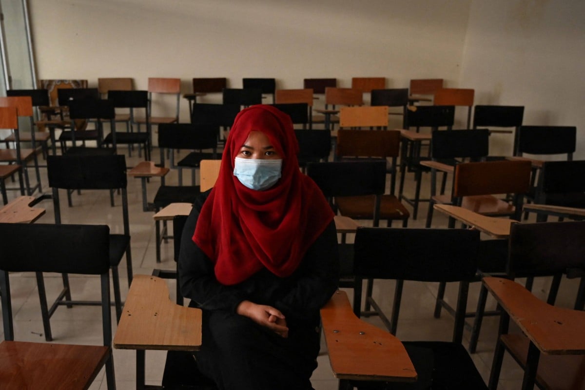 A student sits inside a classroom after private universities reopened in Kabul on September 6, 2021. The Taliban have ordered that women attending private universities must wear an abaya robe and niqab covering most of the face, and classes must be segregated by sex or divided by a curtain. Photo: AFP