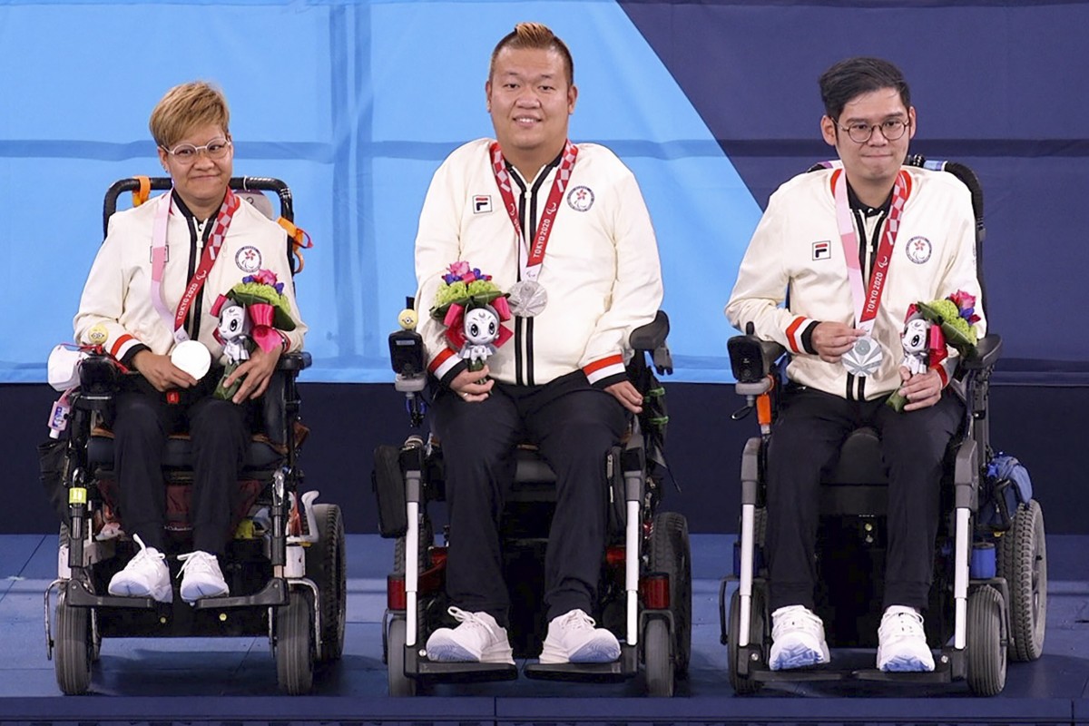 Hong Kong boccia players, Vivian Lau Wai-yan (from left), Leung Yuk-wing and reserve player Raymond Wong Kwan-hang, celebrate on the podium after winning silver in the mixed pair BC4 event at the Tokyo Paralympics. Photo: HK Paralympic Committee