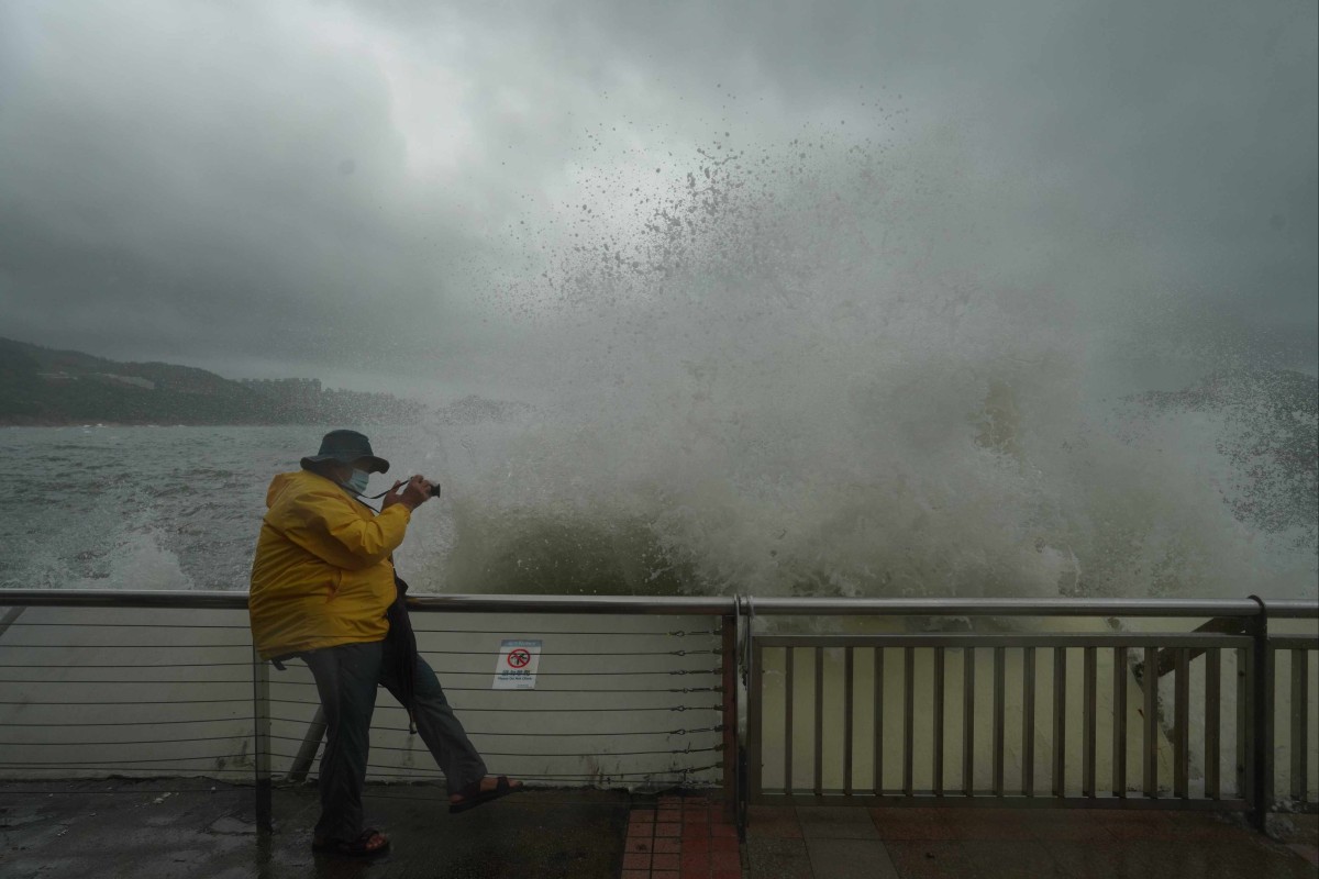 A man takes photos along the waterfront in Heng Fa Chuen, Hong Kong, on Wednesday. Photo: Winson Wong
