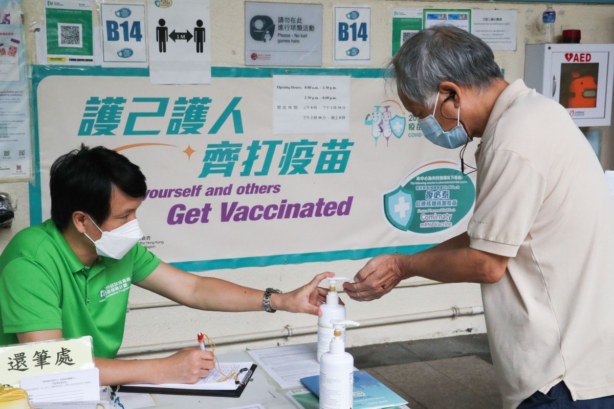 People queue up for the BioNTech coronavirus vaccine at Choi Hung Road Badminton Centre. The Hong Kong government announced it would offer booster shots to the elderly and vulnerable beginning next week. Photo: SCMP/ Edmond So