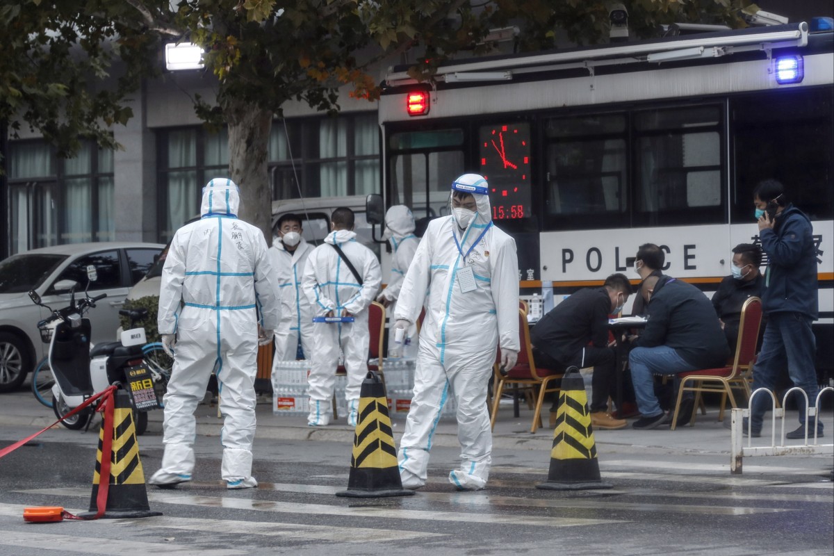 Epidemic prevention and control staff wearing protective suits guard the entrance to a residential neighbourhood under lockdown due to coronavirus cases at the Hongfuyuan residential community in the Changping district of Beijing, China. Photo: EPA-EFE