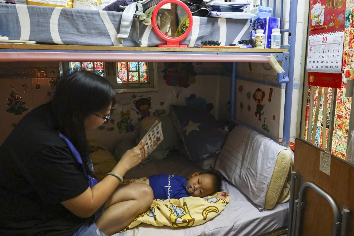 Fandy Wong (left) fans her one-year-old baby with a book, as their landlord has neglected to fix their air conditioner for years. Photo: Dickson Lee