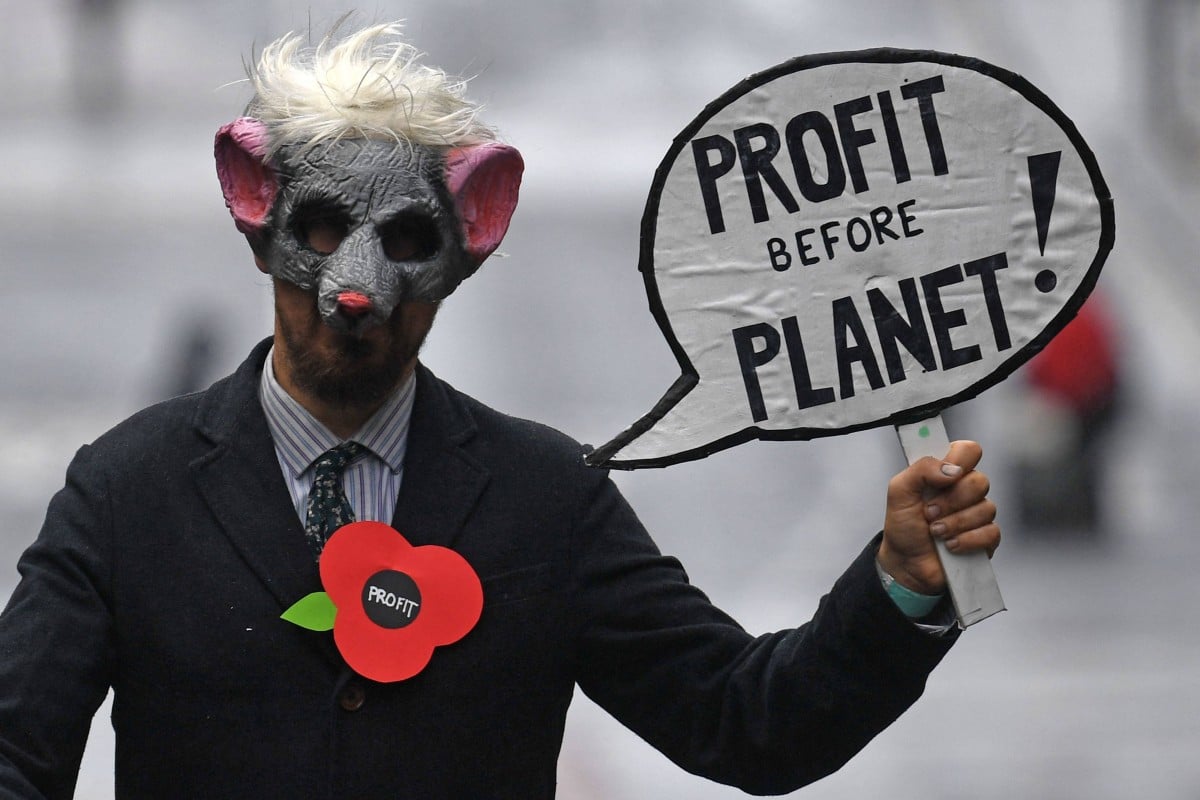 A demonstrator holds up a sign as he attends a protest rally during a global day of action on climate change in Glasgow on November 6, 2021, during the COP26 UN Climate Change Conference. Photo: AFP