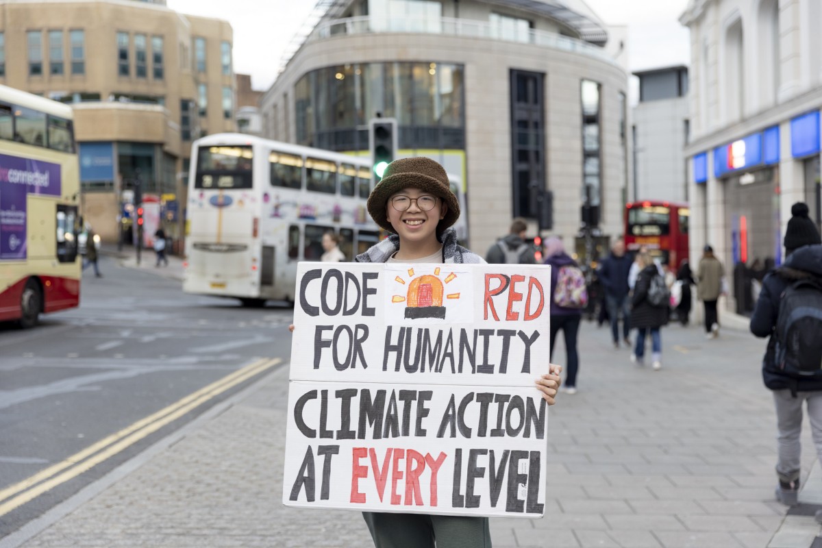 Lance Lau was well-known in Hong Kong for standing outside his school with signs to raise awareness for climate change. Now he lives in Britain, but he still continues his activism. Photo: Lance Lau Hin-yi