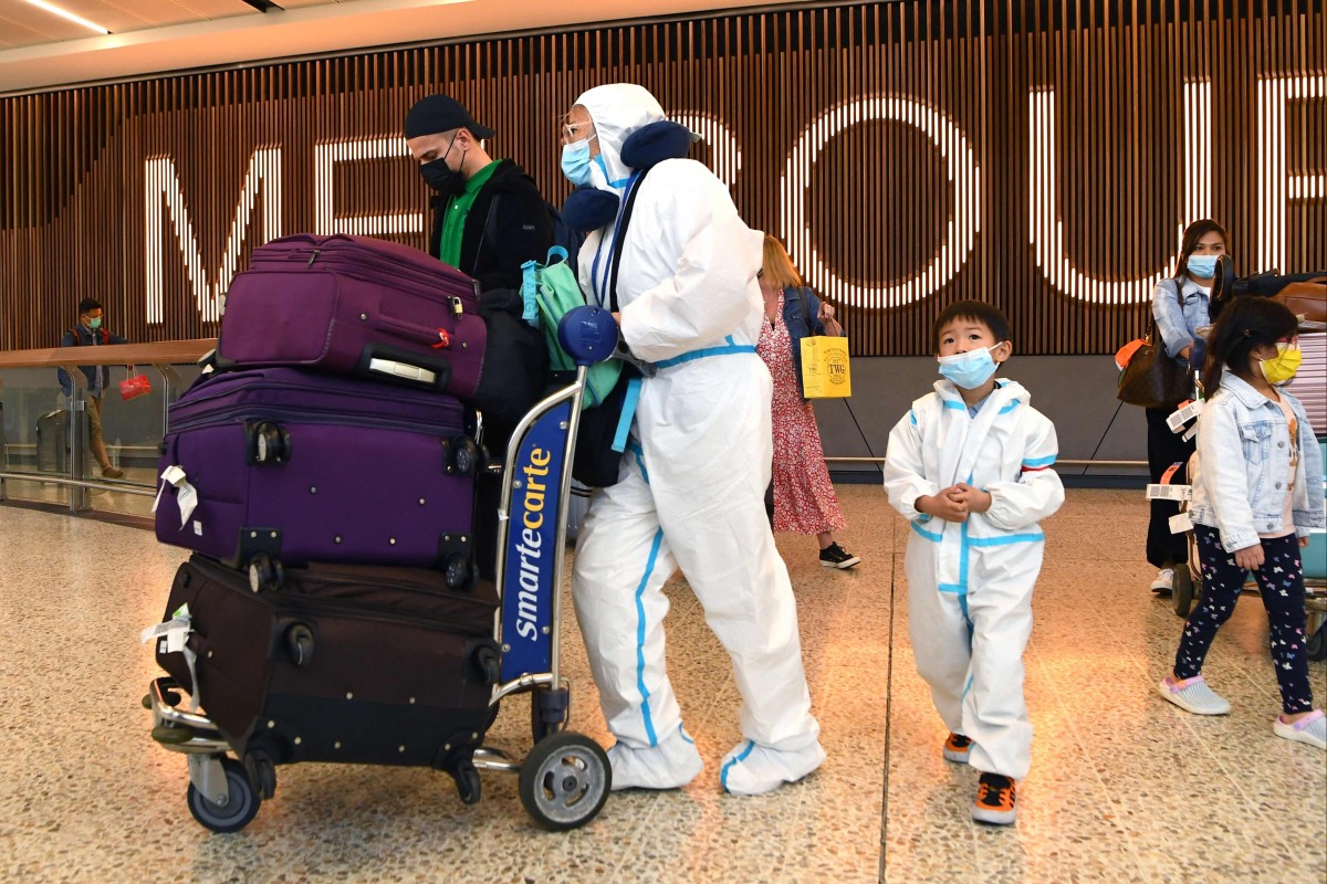 International travellers wearing personal protective equipment arrive at Melbourne’s Tullamarine Airport on November 29, 2021, as Australia records its first cases of the Omicron variant of Covid-19. Photo: AFP