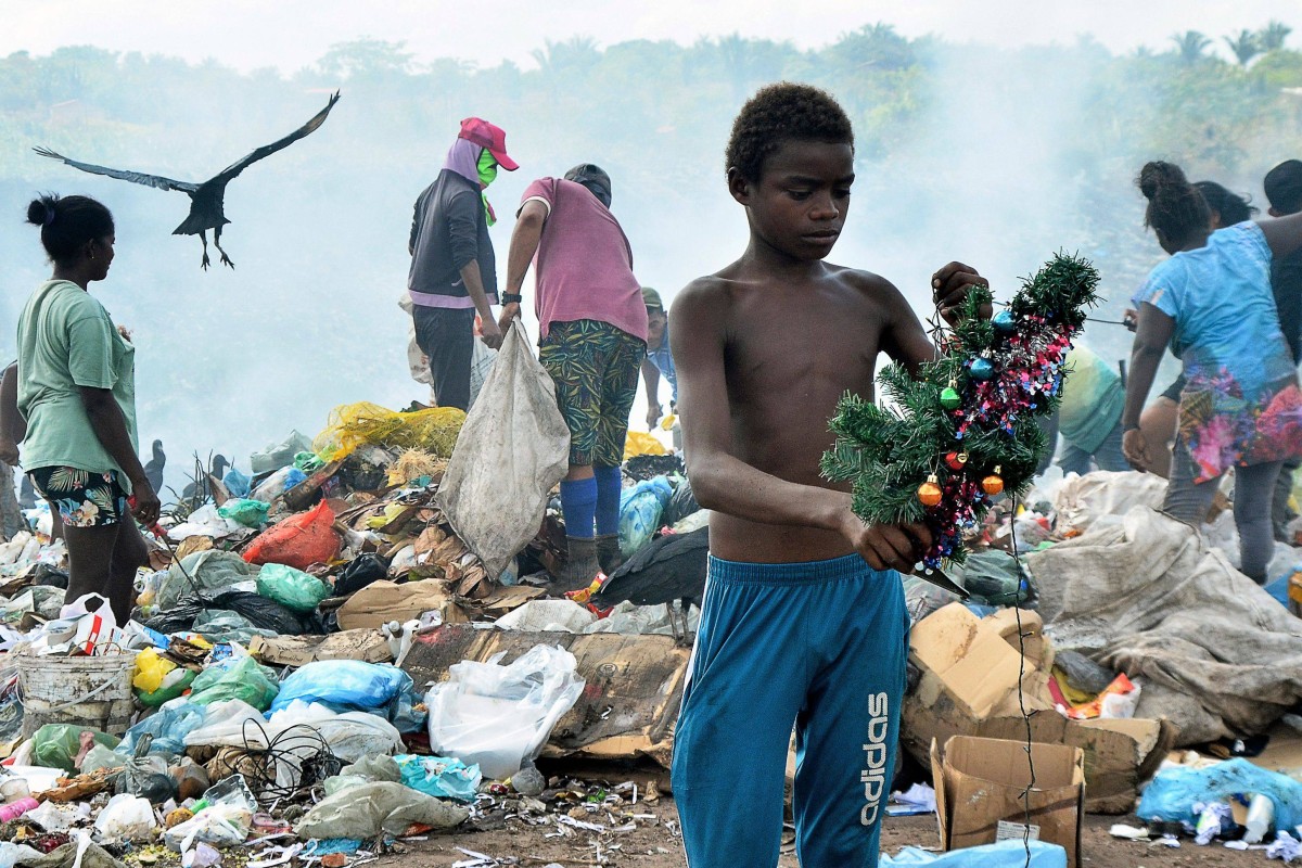 An illegal garbage dump seems an unlikely setting for a holiday story, but when a photojournalist captured 12-year-old Gabriel Silva pulling a Christmas tree from a mountain of trash, the image quickly went viral. Photo: AFP