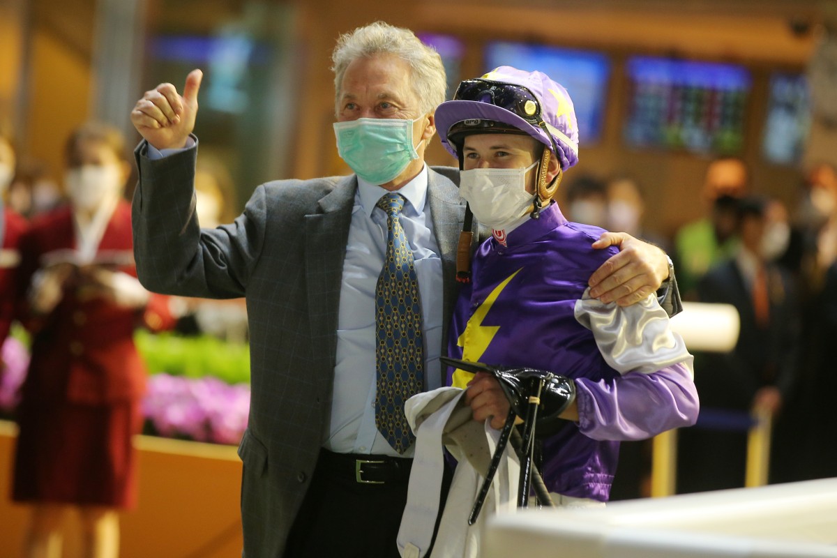 Trainer David Ferraris celebrates a win with his son Luke. Photo: Kenneth Chan