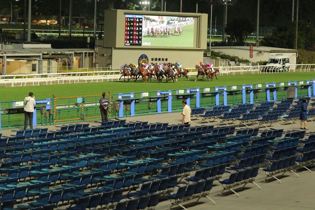 Horses race in front of an empty public area at Happy Valley on Wednesday night. Photos: Kenneth Chan