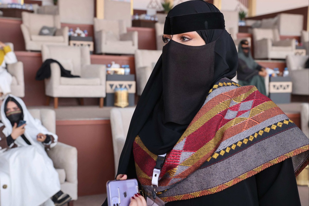 Saudi camel owner Lamia al-Rashidi talks to reporters about taking part for the first time in the King Abdelaziz Camel Festival. Photo: AFP