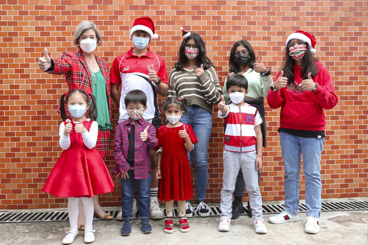 (Front row, from left to right) Early Childhood 2 Angel Li Chi-yiu; Grade 1 Junior Hirotake Amemiya; Early Childhood 2 Tashi Rajora; Grade 1 Purav Kothari; (Back row, left to right) Anita Simpson; Grade 12 Maxim Atepolikhin; Grade 12 Palak Gandji; Grade 8 Keertidha Sindar, and Grade 6 Ayleen Ahmad pose for a picture at the ‘Wearing red and green” event at American International School. Photo: Edmond So
