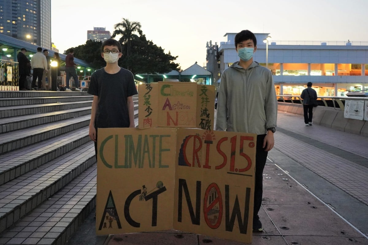 Every Friday after school, secondary school students Ennan Qiu (left) and Max Fung take to the streets of Hong Kong to raise awareness about the climate emergency. Photo: Kelly Fung