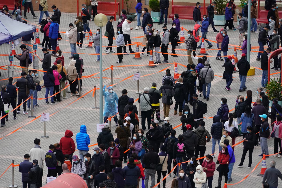 People wait for Covid-19 tests at a mobile testing station at Lek Yuen Community Hall in Sha Tin. The Hong Kong government recently announced its toughest social distancing measures since June 2020, as cases of the Omicron variant skyrocket to record new numbers. Photo: Felix Wong