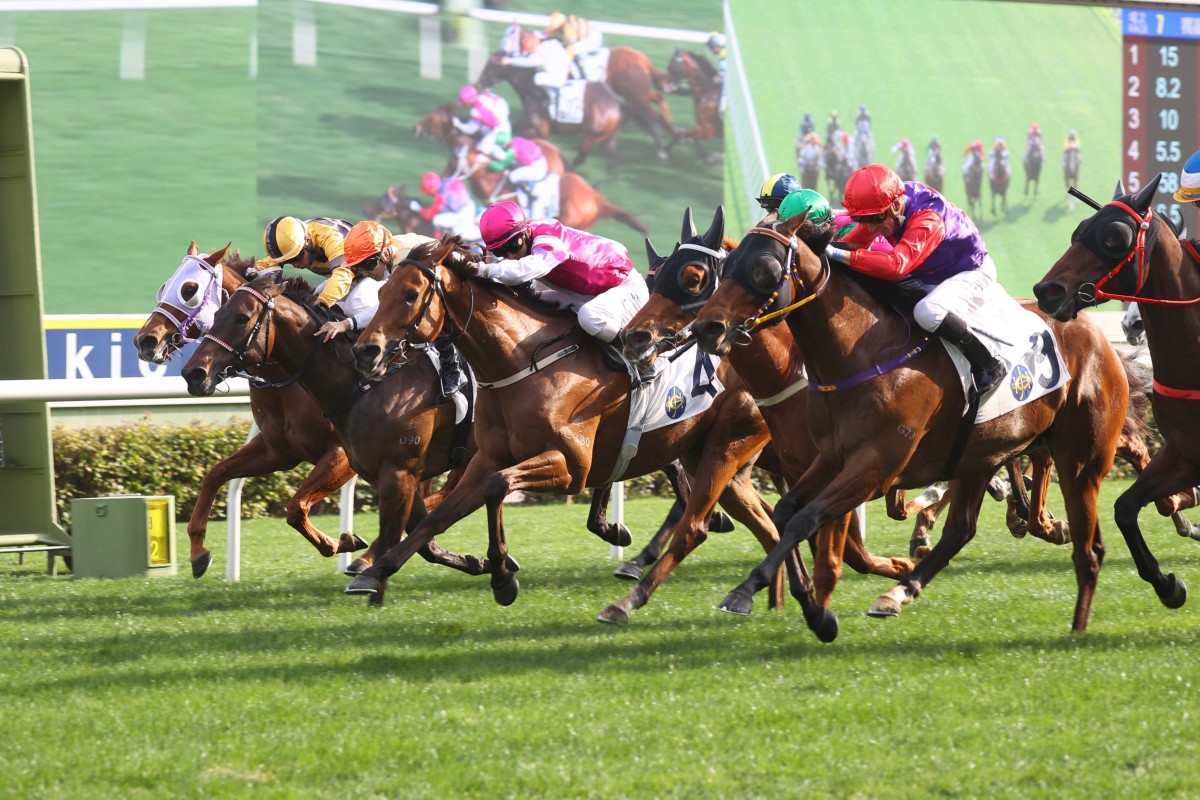 Debutant Texas Moon (red hat, nearest camera) bursts through late to win under Daniel Moor at Sha Tin. Photo: HKJC