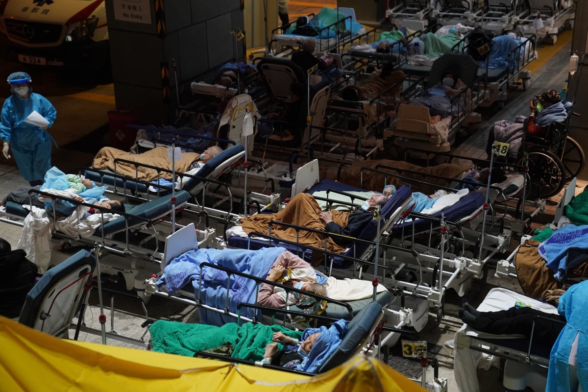 Patients displaying Covid-19 symptoms lay in beds at a temporary holding area outside Caritas Medical Centre in Cheung Sha Wan. Photo: Sam Tsang