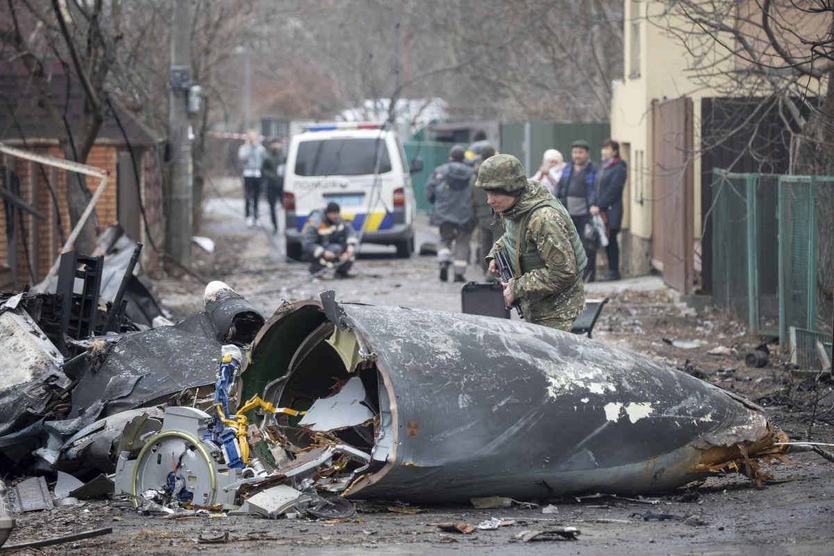 A Ukrainian Army soldier inspects fragments of a downed aircraft in Kyiv, Ukraine. It was unclear what aircraft crashed and what brought it down amid the Russian invasion. Photo: AP