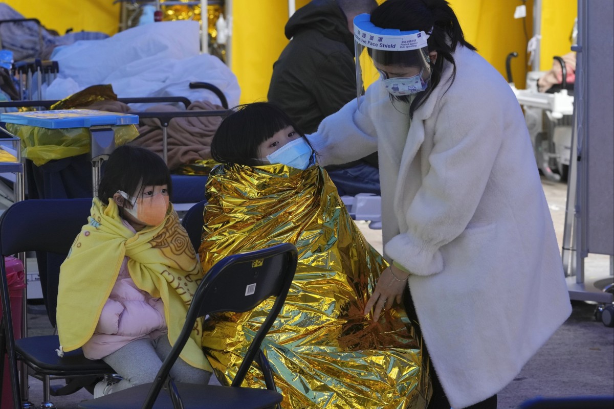 Children waiting at a temporary makeshift treatment area outside Caritas Medical Centre. Photo: AP
