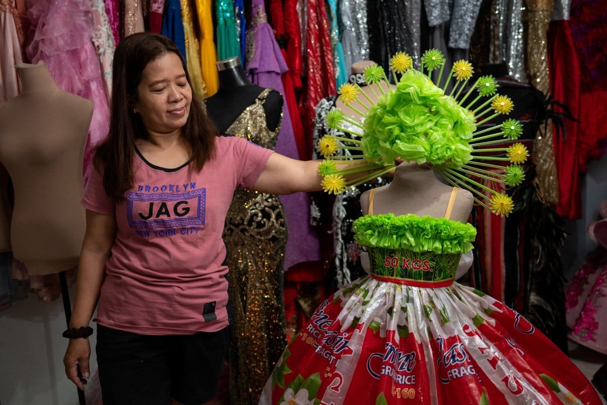 Seamstress and designer Nora Buenviaje shows an outfit made of recycled sacks of rice, plastic bags and straws at her shop in the Philippines. Photos: Reuters